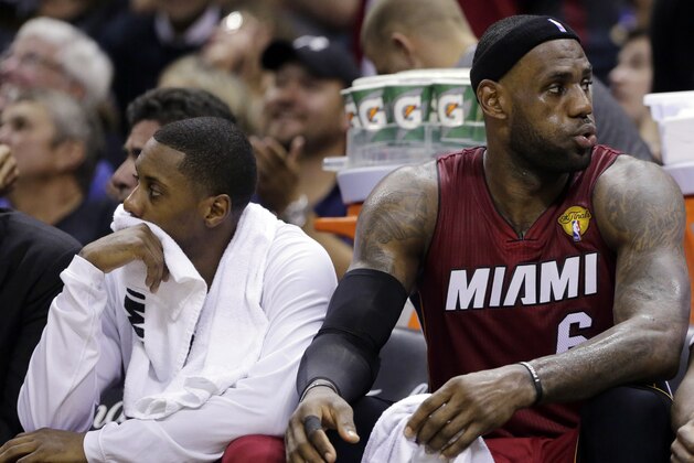 Miami Heat guard Mario Chalmers, left, and forward LeBron James watch action against the San Antonio Spurs from the bench during the second half in Game 1 of the NBA basketball finals on Thursday, June 5, 2014 in San Antonio. (AP Photo/Eric Gay)