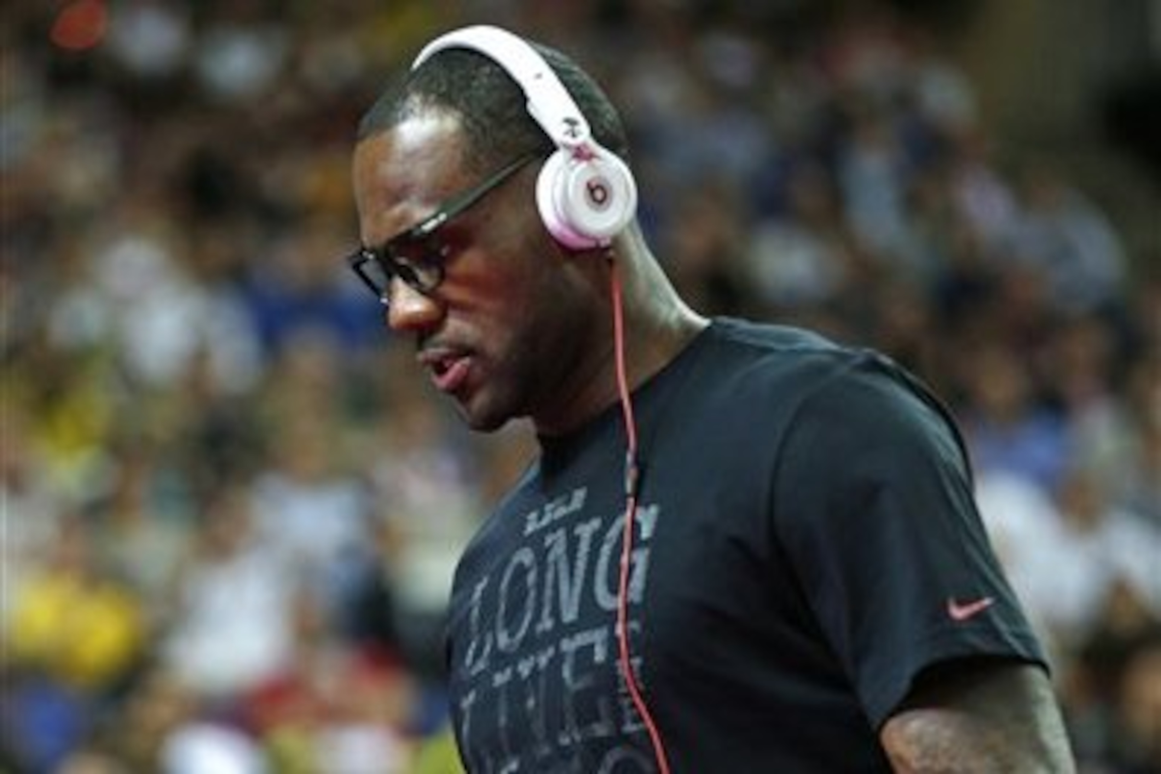 USA's Lebron James wear headphones as he arrives to watch Argentina play Brazil during a men's quarterfinals basketball game at the 2012 Summer Olympics, Wednesday, Aug. 8, 2012, in London. (AP Photo/Charles Krupa)