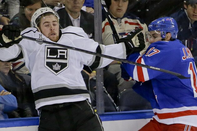 Los Angeles Kings left wing Tanner Pearson (70), left, crashes the boards with New York Rangers defenseman John Moore (17) in the third period during Game 4 of the NHL hockey Stanley Cup Final, Wednesday, June 11, 2014, in New York. (AP Photo/Frank Franklin II)