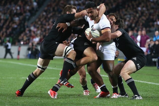 AUCKLAND, NEW ZEALAND - JUNE 07:  Manu Tuilagi of England is stopped by the All Black defence during the International Test Match between the New Zealand All Blacks and England at Eden Park on June 7, 2014 in Auckland, New Zealand.  (Photo by David Rogers/Getty Images)