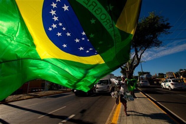 A street vendor sells representations of Brazil's national flags near the Arena Castelao  in  Fortaleza, Brazil, Wednesday, June 11, 2014.  The Brazil 2014 Word Cup soccer tournament is set to begin Thursday. (AP Photo/Fernando Llano)