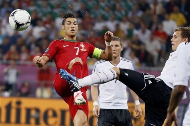 Portugal's Cristiano Ronaldo, left, and Germany's Holger Badstuber vie for the ball  during the Euro 2012 soccer championship Group B match between Germany and Portugal in Lviv, Ukraine, Saturday, June 9, 2012. (AP Photo/Frank Augstein)