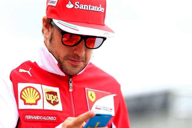 MONTREAL, QC - JUNE 05:  Fernando Alonso of Spain and Ferrari walksacross the paddock ahead of the Canadian Formula One Grand Prix at Circuit Gilles Villeneuve on June 5, 2014 in Montreal, Canada.  (Photo by Mark Thompson/Getty Images)