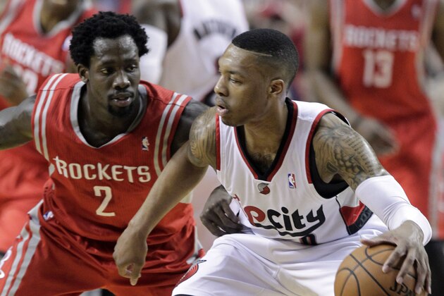 Portland Trail Blazers guard Damian Lillard, right, works against Houston Rockets guard Patrick Beverley during the first half of Game 3 of an NBA basketball first-round playoff series in Portland, Ore., Friday, April 25, 2014. (AP Photo/Don Ryan)