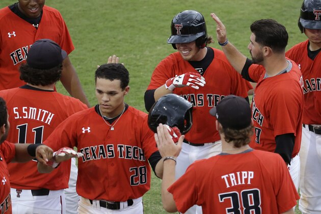 Texas Tech's Devon Conley (28) and Tim Proudfoot, second from right, rear, are congratulated by their teammates after scoring in the ninth inning on a single by Zach Davis against Miami during an NCAA college baseball regional tournament in Coral Gables, Fla., Monday, June 2, 2014.  Texas Tech defeated Miami 4-0 to advance to the Super Regionals. (AP Photo/Lynne Sladky)