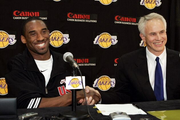 Los Angeles Lakers Kobe Bryant, left, shakes hands with general manger Mitch Kupchak after signing his contract during a news conference Thursday, July 15, 2004, at the team's training facility in El Segundo, Calif. Bryant chose the Lakers over the Clippers, remaining with the team he joined in 1996 at age 18 and later helped win three NBA championships (AP Photo/Kevork Djansezian)