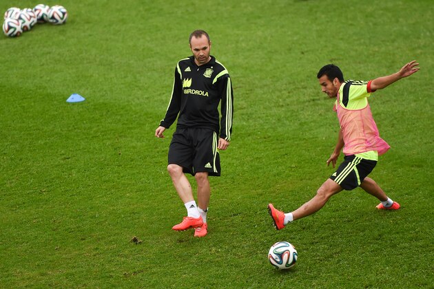 CURITIBA, BRAZIL - JUNE 10:  Andres Iniesta (L) and Pedro Rodriguez of Spain competes for the ball during a Spain training session at the Centro de Entrenamiento do Caju prior to a Spain training session on June 10, 2014 in Curitiba, Brazil.  (Photo by David Ramos/Getty Images)