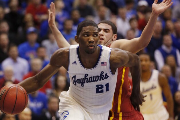 Kansas center Joel Embiid (21) works around Iowa State forward Georges Niang, back, during the first half of an NCAA college basketball game in Lawrence, Kan., Wednesday, Jan. 29, 2014. Kansas won 92-81. (AP Photo/Orlin Wagner)