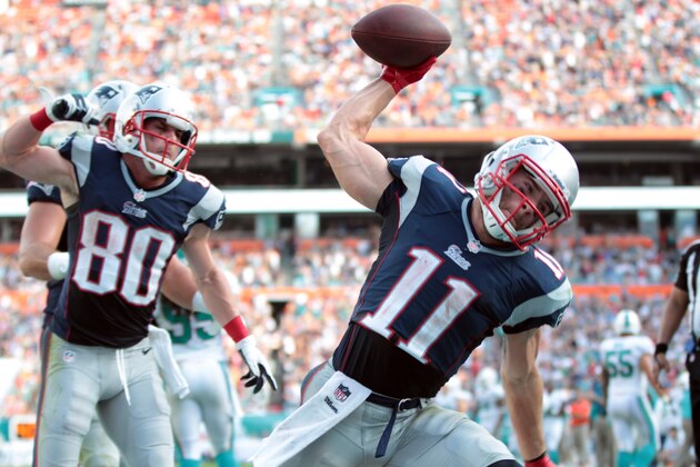 New England Patriots wide receiver Julian Edelman (11) spikes the ball after scoring a touchdown during the second half of an NFL football game against the Miami Dolphins Sunday, Dec. 15, 2013, in Miami Gardens, Fla. (AP Photo/J Pat Carter)