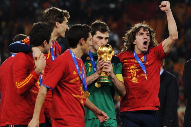 JOHANNESBURG, SOUTH AFRICA - JULY 11:  Iker Casillas of Spain kisses the World Cup trophy as the Spain team celebrate victory following the 2010 FIFA World Cup South Africa Final match between Netherlands and Spain at Soccer City Stadium on July 11, 2010 in Johannesburg, South Africa.  (Photo by Jasper Juinen/Getty Images)