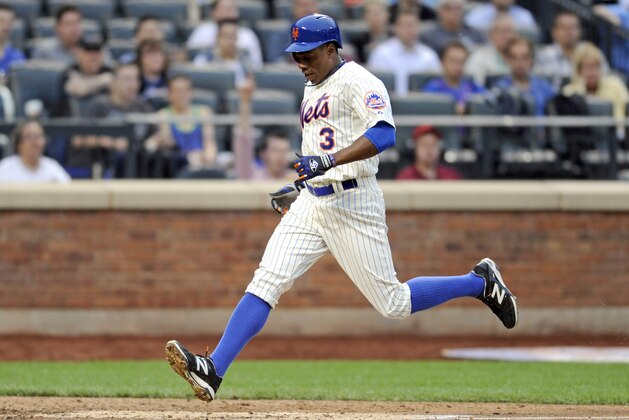 New York Mets' Curtis Granderson scores on a sacrifice fly by Lucas Duda during the second inning of a baseball game against the Milwaukee Brewers Wednesday, June 11, 2014, at Citi Field in New York. (AP Photo/Bill Kostroun)