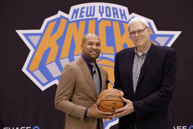 New York Knicks president Phil Jackson, right, poses for a picture with Derek Fisher during a news conference in Tarrytown, N.Y., Tuesday, June 10, 2014. The New York Knicks hired Fisher as their new coach on Tuesday, with Jackson turning to one of his trustiest former players. (AP Photo/Seth Wenig)