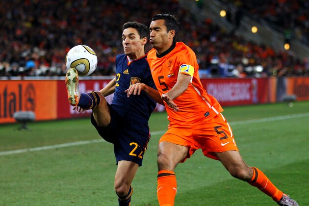 JOHANNESBURG, SOUTH AFRICA - JULY 11: Jesus Navas of Spain and Giovanni Van Bronckhorst of the Netherlands battle for the ball during the 2010 FIFA World Cup South Africa Final match between Netherlands and Spain at Soccer City Stadium on July 11, 2010 in Johannesburg, South Africa. (Photo by Lars Baron/Getty Images) JOHANNESBURG, SOUTH AFRICA - JULY 11: Jesus Navas of Spain and Giovanni Van Bronckhorst of the Netherlands battle for the ball during the 2010 FIFA World Cup South Africa Final match between Netherlands and Spain at Soccer City Stadium on July 11, 2010 in Johannesburg, South Africa. (Photo by Lars Baron/Getty Images)