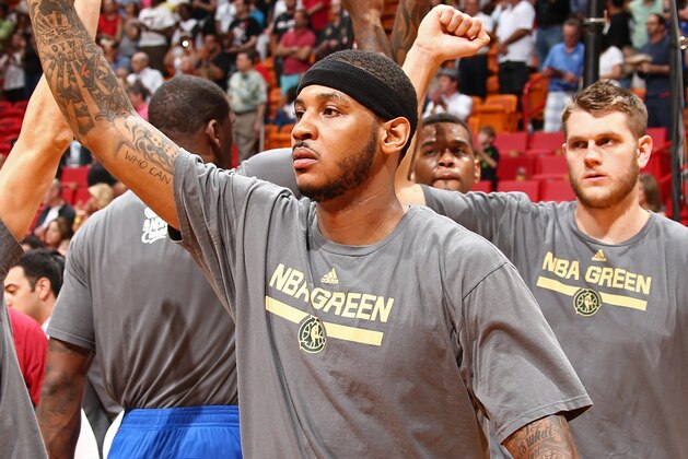 MIAMI, FL - APRIL 6: Carmelo Anthony #7 of the New York Knicks warms up with teammates before the game against the Miami Heat on April 6, 2014 at American Airlines Arena in Miami, Florida.  NOTE TO USER: User expressly acknowledges and agrees that, by downloading and or using this photograph, User is consenting to the terms and conditions of the Getty Images License Agreement. Mandatory Copyright Notice: Copyright 2014 NBAE  (Photo by Nathaniel S. Butler/NBAE via Getty Images)