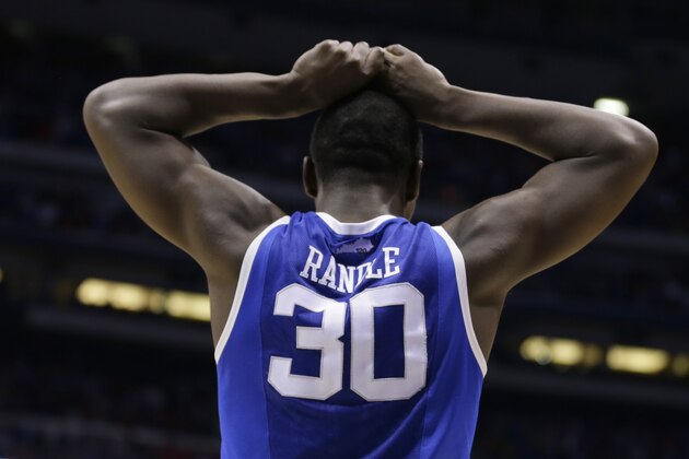 Kentucky's Julius Randle reacts to a foul call during the second half of an NCAA Midwest Regional semifinal college basketball tournament game against the Louisville Saturday, March 29, 2014, in Indianapolis. (AP Photo/Michael Conroy)