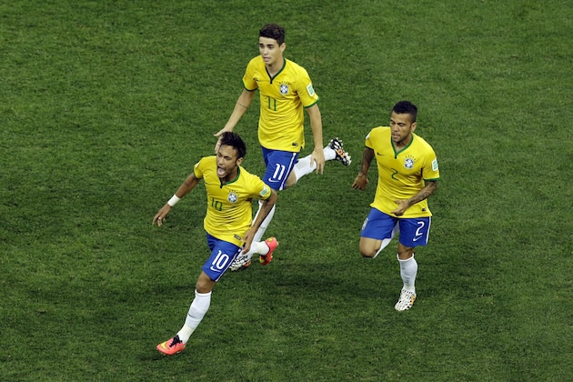 Brazil's Neymar, left, celebrates scoring his side's first goal during the group A World Cup soccer match between Brazil and Croatia, the opening game of the tournament, in the Itaquerao Stadium in Sao Paulo, Brazil, Thursday, June 12, 2014. (AP Photo/Thanassis Stavrakis)