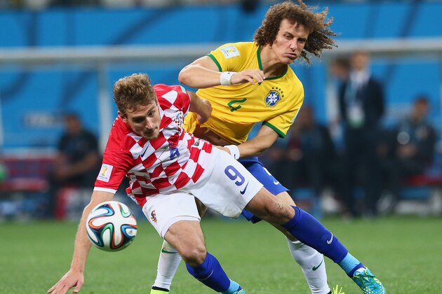 SAO PAULO, BRAZIL - JUNE 12:  David Luiz of Brazil battles with Nikica Jelavic of Croatia during the 2014 FIFA World Cup Brazil Group A match between Brazil and Croatia at Arena de Sao Paulo on June 12, 2014 in Sao Paulo, Brazil.  (Photo by Kevin Cox/Getty Images)