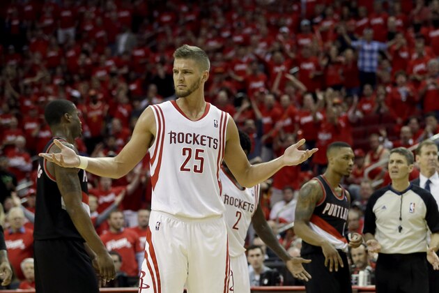 Houston Rockets' Chandler Parsons (25) reacts after Portland Trail Blazers' Robin Lopez hit him on the shoulder after fouling out during overtime in Game 1 of an opening-round NBA basketball playoff series Sunday, April 20, 2014, in Houston. The Trail Blazers won 122-120 in overtime. (AP Photo/David J. Phillip)