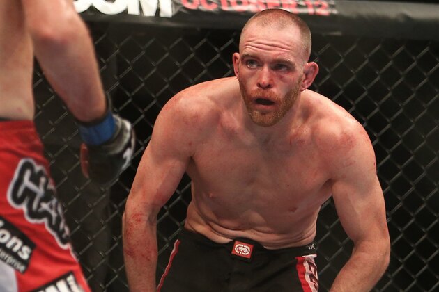 September 22, 2012; Toronto, ON, CANADA; UFC fighter T.J. Grant fights against UFC fighter Evan Dunham (left) in the lightweight bout during UFC 152 at the Air Canada Centre. Mandatory Credit: Tom Szczerbowski-USA TODAY Sports