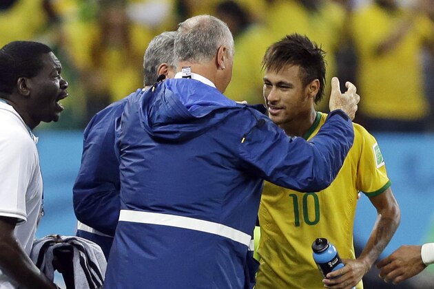 Brazil's Neymar is congratulated by Brazil's coach Luiz Felipe Scolari after Neymar scored during the group A World Cup soccer match between Brazil and Croatia, the opening game of the tournament, in the Itaquerao Stadium in Sao Paulo, Brazil, Thursday, June 12, 2014.  (AP Photo/Kirsty Wigglesworth)