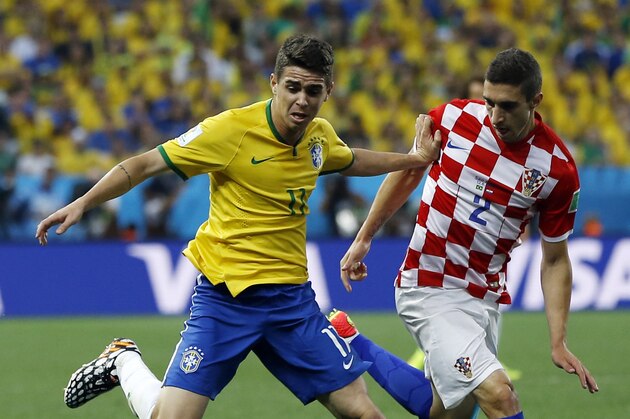 Brazil's Oscar, left, and Croatia's Sime Vrsaljko battle for the ball during the group A World Cup soccer match between Brazil and Croatia, the opening game of the tournament, in the Itaquerao Stadium in Sao Paulo, Brazil, Thursday, June 12, 2014. (AP Photo/Kirsty Wigglesworth)