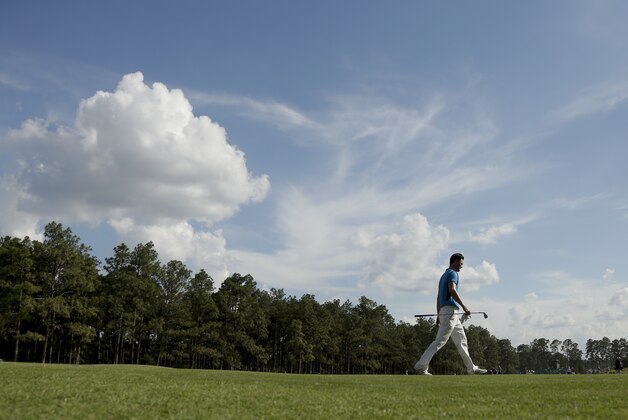 Martin Kaymer, of Germany, walks down the 13th fairway during the first round of the U.S. Open golf tournament in Pinehurst, N.C., Thursday, June 12, 2014. (AP Photo/Charlie Riedel)