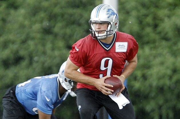 Detroit Lions quarterback Matthew Stafford (9) drops back to hand off the ball during the final day of NFl football minicamp Thursday, June 12, 2014, in Allen Park, Mich. (AP Photo/Duane Burleson)