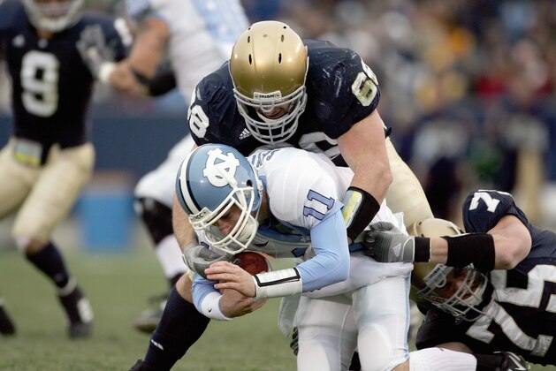 SOUTH BEND, IN - NOVEMBER 4:  Quarterback Cam Sexton #11 of the North Carolina Tar Heels is sacked by Ryan Harris #68 of the Notre Dame Fighting Irish on November 4, 2006 at Notre Dame Stadium in South Bend, Indiana. (Photo by Jonathan Daniel/Getty Images)