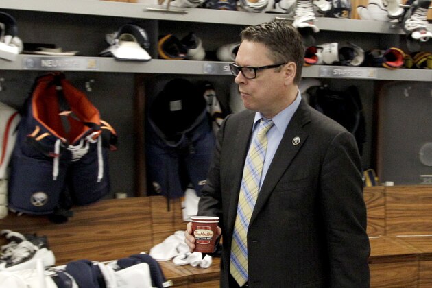 Buffalo Sabres general manager Tim Murray exits the Sabres locker room after players gathered for the last time on Monday, April 14, 2014, in Buffalo, N.Y. (AP Photo/Nick LoVerde)