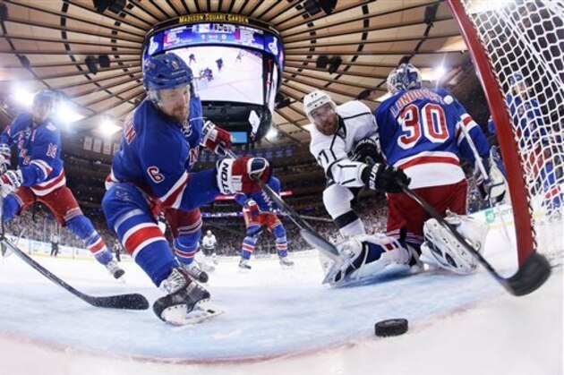 AP10ThingsToSee- New York Rangers defenseman Anton Stralman (6) reaches to save the puck from crossing the goal line as Los Angeles Kings center Jeff Carter (77) tries to score from behind New York Rangers goalie Henrik Lundqvist (30) in the first period during Game 4 of the NHL hockey Stanley Cup finals, Wednesday, June 11, 2014, in New York. (AP Photo/Bruce Bennett, Pool)
