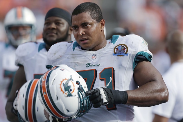 En esta foto del 16 de diciembre de 2012, Jonathan Martin observa el partido de su equipo, los Dolphins de Miami, contra los Jaguars de Jacksonville. El martes 11 de marzo de 2014, los Dolphins pactaron un canje con los 49ers de San Francisco para ceder a Martin, quien denunció la campaña anterior a un compañero por hostigamiento (AP Foto/Wilfredo Lee)