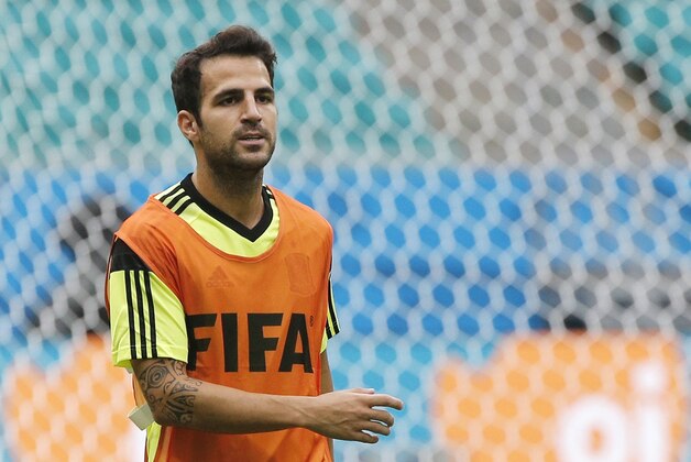 Spain's Cesc Fabregas warms up during an official training session the day before the group B World Cup soccer match between Spain and the Netherlands at the Arena Ponte Nova in Salvador, Brazil, Thursday, June 12, 2014.  (AP Photo/Christophe Ena)