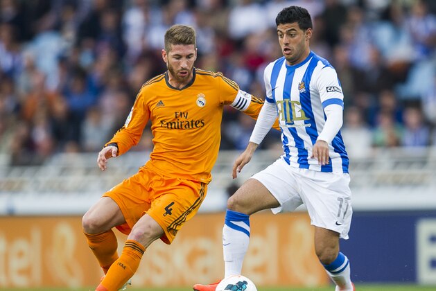 SAN SEBASTIAN, SPAIN - APRIL 05:  Sergio Ramos of Real Madrid CF duels for the ball with Carlos Vela of Real Sociedad during the La Liga match between Real Sociedad and Real Madrid CF at Estadio Anoeta on April 5, 2014 in San Sebastian, Spain.  (Photo by Juan Manuel Serrano Arce/Getty Images)