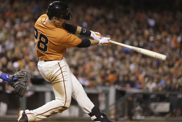 San Francisco Giants' Buster Posey swings for a two run home run off New York Mets' Carlos Torres in the eighth inning of a baseball game Friday, June 6, 2014, in San Francisco. (AP Photo/Ben Margot)