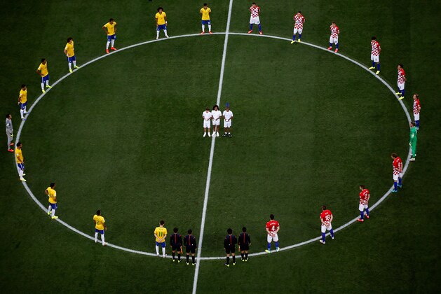 SAO PAULO, BRAZIL - JUNE 12:  Brazil and Croatia players stand around the center circle as doves are released before the 2014 FIFA World Cup Brazil Group A match between Brazil and Croatia at Arena de Sao Paulo on June 12, 2014 in Sao Paulo, Brazil.  (Photo by Fabrizio Bensch - Pool/Getty Images)