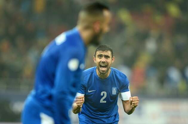 BUCHAREST, ROMANIA - NOVEMBER 19:  Ioannis Maniatis of Greece celebrates winning their play-off match during the FIFA 2014 World Cup Qualifier Play-off Second Leg match between Romania and Greece at the National Arena on November 19, 2013 in Bucharest, Romania.  (Photo by Jamie McDonald/Getty Images)