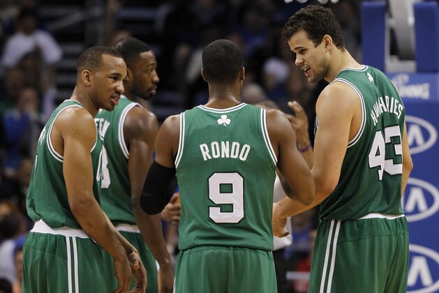 Jan 19, 2014; Orlando, FL, USA; Boston Celtics point guard Rajon Rondo (9) talks with point guard Avery Bradley (L) and center Kris Humphries (R) against the Orlando Magic during the second half  at Amway Center. Orlando Magic won 93-91. Mandatory Credit: Kim Klement-USA TODAY Sports