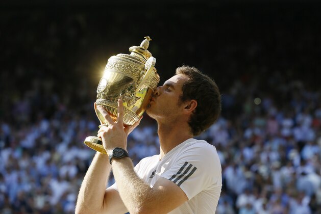 Andy Murray of Britain poses with the trophy after defeating Novak Djokovic of Serbia during the Men's singles final match at the All England Lawn Tennis Championships in Wimbledon, London, Sunday, July 7, 2013. (AP Photo/Kirsty Wigglesworth)