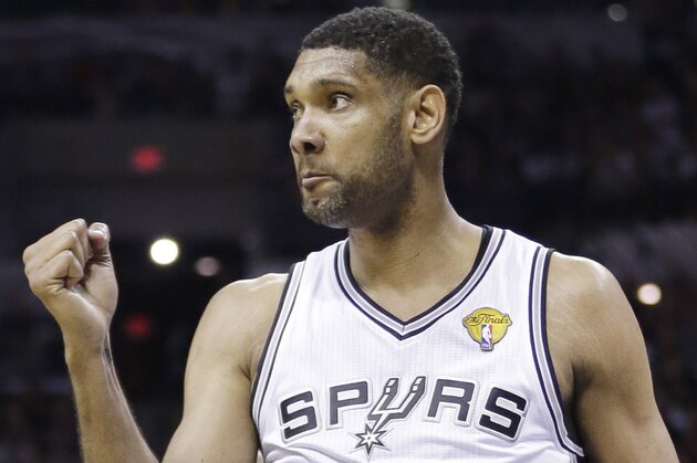 San Antonio Spurs forward Tim Duncan gestures between plays against the Miami Heat during the first half in Game 2 of the NBA basketball finals on Sunday, June 8, 2014, in San Antonio. Miami won 98-96. (AP Photo/Eric Gay)