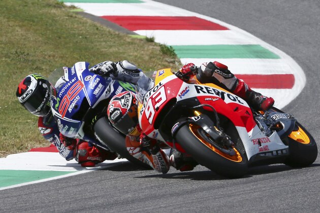 Honda rider Marc Marquez, right, of Spain, and Yamaha rider Jorge Lorenzo, of Spain, challenge for first place during the Italian Moto GP, at the Mugello race circuit, in Scarperia, Italy, Sunday, June 1, 2014. (AP Photo/Antonio Calanni)