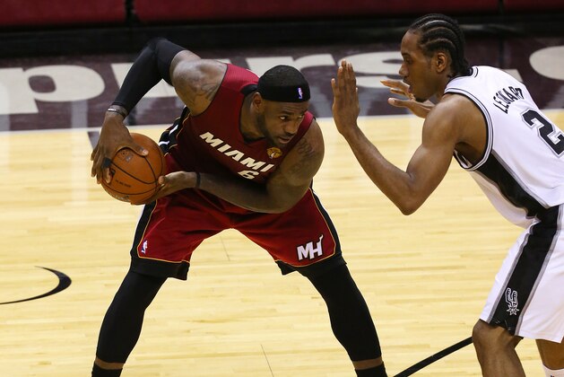 SAN ANTONIO, TX - JUNE 5: LeBron James #6 of the Miami Heat holds the ball away from Kawhi Leonard #2 of the San Antonio Spurs in Game One of the 2014 NBA Finals at the AT&T Center on June 5, 2014 in San Antonio, Texas. NOTE TO USER: User expressly acknowledges and agrees that, by downloading and/or using this photograph, user is consenting to the terms and conditions of the Getty Images License Agreement. (Photo by Chris Covatta/Getty Images)