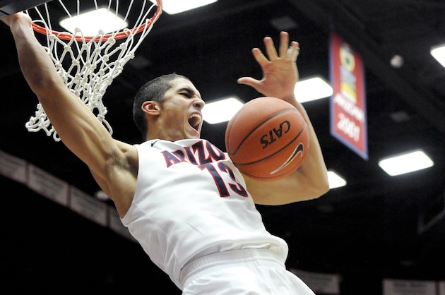 Jan 26, 2014; Tucson, AZ, USA; Arizona Wildcats guard Nick Johnson (13) dunks the ball during the second half against the Utah Utes at McKale Center. Arizona won 65-56. Mandatory Credit: Casey Sapio-USA TODAY Sports