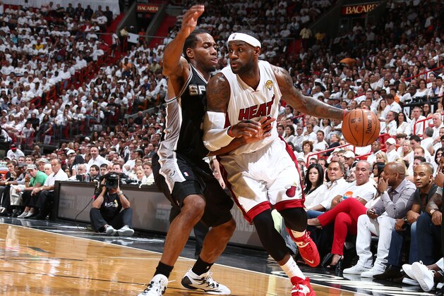 MIAMI, FL - JUNE 12: LeBron James #6 of the Miami Heat drives against Kawhi Leonard #2 of the San Antonio Spurs during Game Four of the 2014 NBA Finals at American Airlines Arena in Miami, Florida on June 12, 2014.  NOTE TO USER: User expressly acknowledges and agrees that, by downloading and or using this photograph, User is consenting to the terms and conditions of the Getty Images License Agreement. Mandatory Copyright Notice: Copyright 2014 NBAE  (Photo by Nathaniel S. Butler/NBAE via Getty Images)