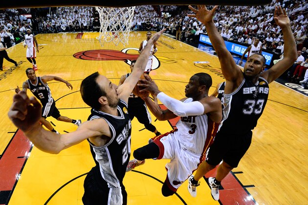 MIAMI, FL - JUNE 12:  Dwyane Wade #3 of the Miami Heat goes to the basket against Manu Ginobili #20 of the San Antonio Spurs during Game Four of the 2014 NBA Finals at American Airlines Arena on June 12, 2014 in Miami, Florida. NOTE TO USER: User expressly acknowledges and agrees that, by downloading and or using this photograph, User is consenting to the terms and conditions of the Getty Images License Agreement.  (Photo by Larry W. Smith -  Pool/Getty Images)