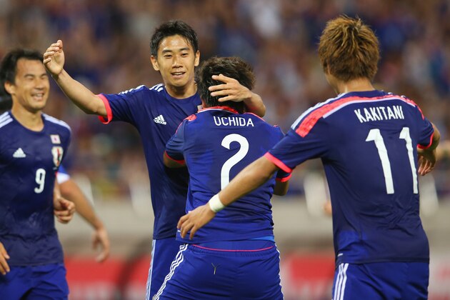 SAITAMA, JAPAN - MAY 27:  (EDITORIAL USE ONLY)  Shinji Kagawa of Japan congratulates Atsuto Uchida after he scored a goal during the Kirin Challenge Cup international friendly match between Japan and Cyprus at Saitama Stadium on May 27, 2014 in Saitama, Japan.  (Photo by Mark Kolbe/Getty Images)