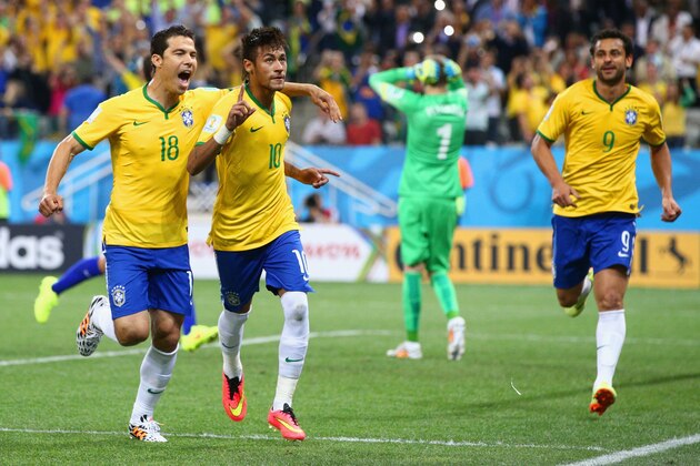 SAO PAULO, BRAZIL - JUNE 12:  Neymar of Brazil (C) celebrates his second goal with Hernanes in the second half during the 2014 FIFA World Cup Brazil Group A match between Brazil and Croatia at Arena de Sao Paulo on June 12, 2014 in Sao Paulo, Brazil.  (Photo by Adam Pretty/Getty Images)