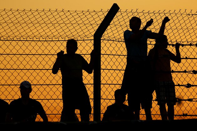 LE MANS, FRANCE - JUNE 12: Fans scale the fence during qualifying session to get a closer looks at the action on June 12, 2014 in Le Mans, France. (Photo by Andrew Hone/Getty Images)