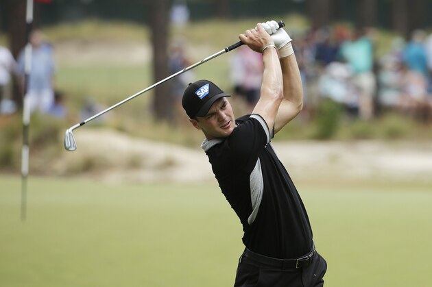 Martin Kaymer, of Germany, watches his tee shot on the seventh hole during the second round of the U.S. Open golf tournament in Pinehurst, N.C., Friday, June 13, 2014. (AP Photo/Chuck Burton)