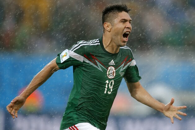 Mexico's Oribe Peralta celebrates his goal during the second half of the group A World Cup soccer match between Mexico and Cameroon in the Arena das Dunas in Natal, Brazil, Friday, June 13, 2014.  (AP Photo/Eduardo Verdugo)