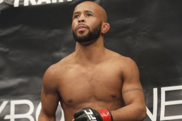Defending Champion Demetrious Johnson warms up before fighting Joseph Benavidez  for the UFC Flyweight Mixed Martial Arts title in Sacramento, Calif., on Saturday, Dec. 14, 2013.(AP Photo/Steve Yeater)